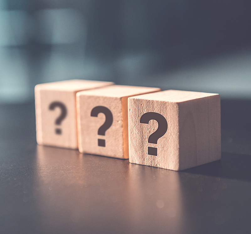 ? Questions Mark word in wooden cube block on table background. FAQ  Answer, Q&A.